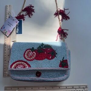 Viral beaded tomato with tassels bag.